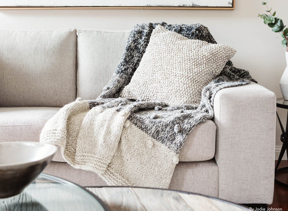 Throw Pillow And Blanket On Cozy Sofa